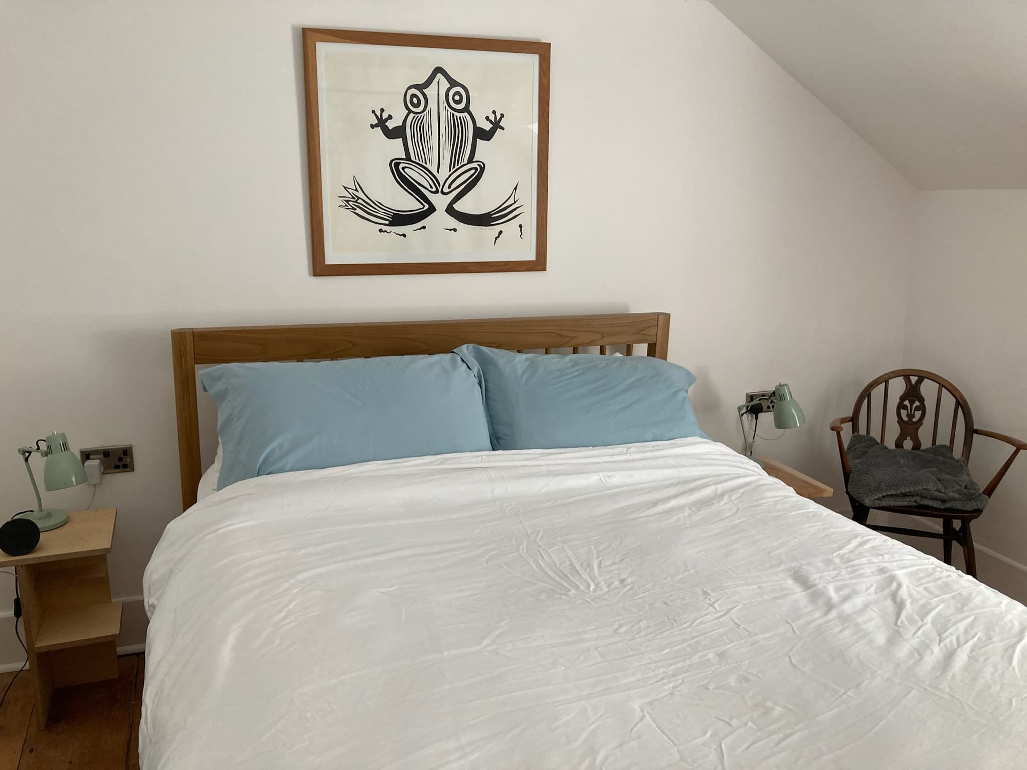 Double bedroom with handmade oak furniture and Ercol chair